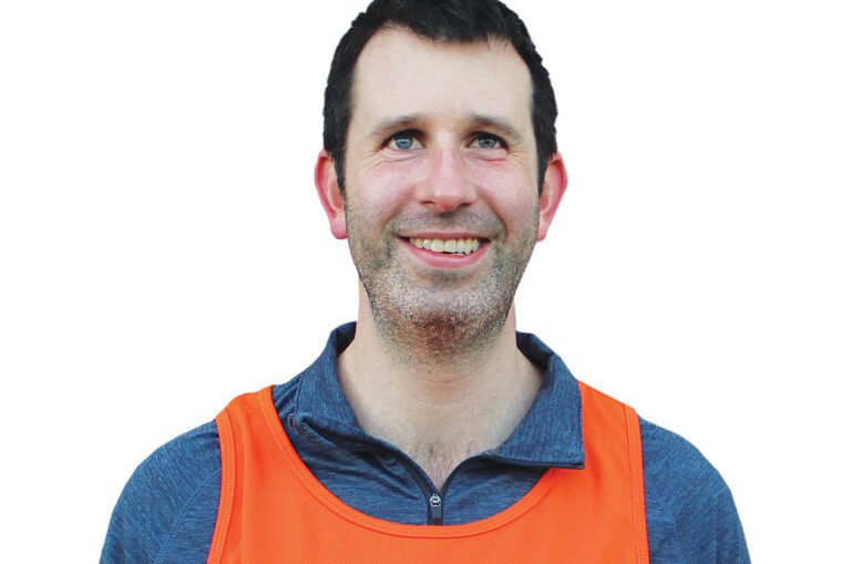 Image of a man wearing a Guide Dogs Queensland athletic shirt