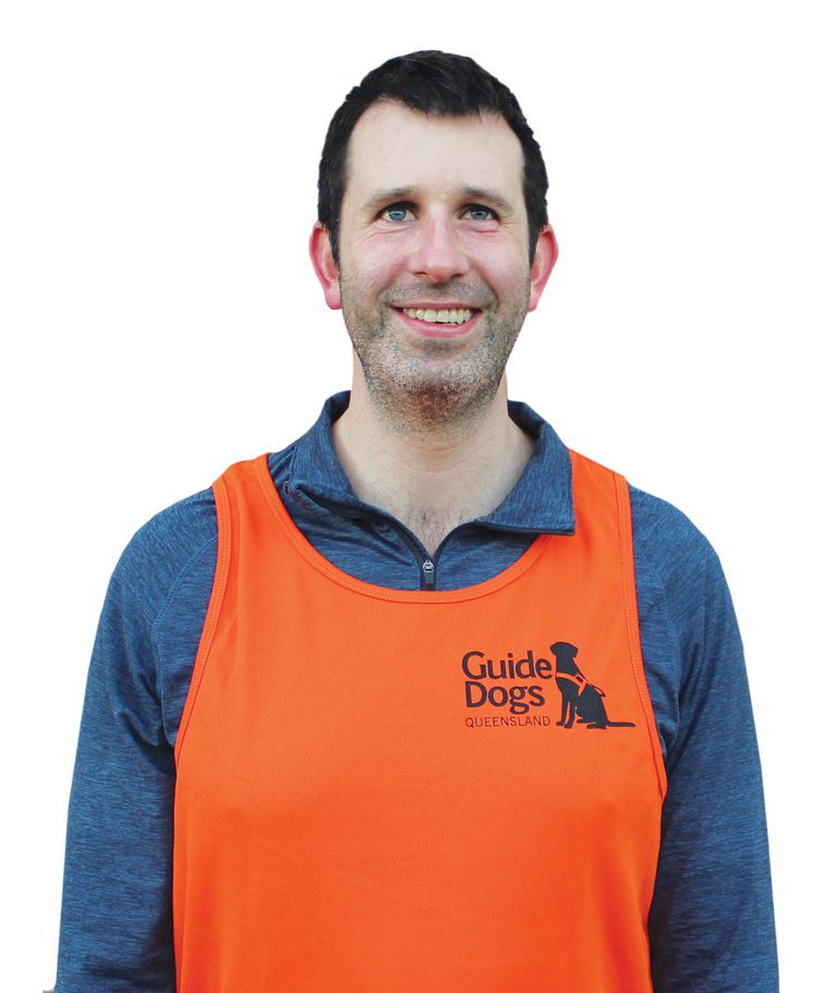 Image of a man wearing a Guide Dogs Queensland athletic shirt