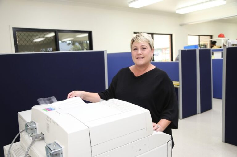 Image of a woman using a photocopier in an office