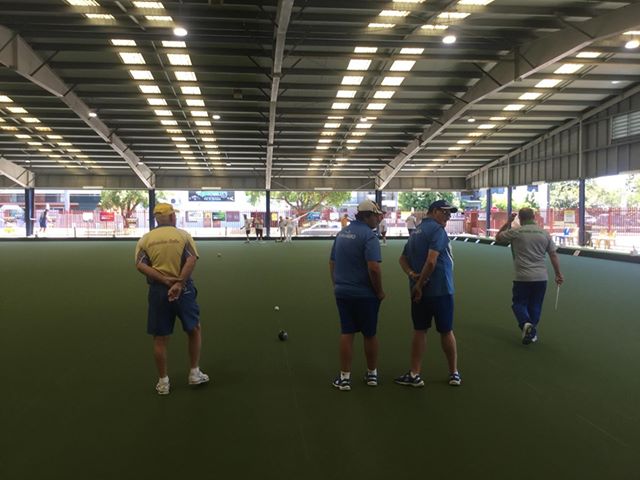 Fred playing lawn bowls with other members of the bowls club