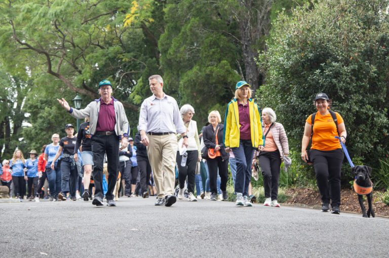 A crowd of people are pictured walking with CEO Jock Beveridge, Professor Nimmo and Her Excellency the Honourable Dr Jeannette Young, Governor of Queensland leading the way.