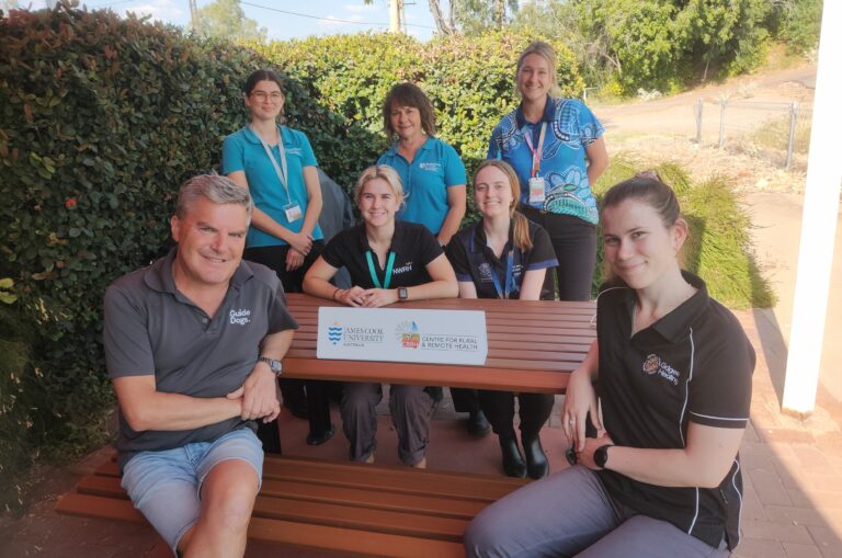Guide Dogs Principal Advisor, Access and Engagement, Jeremy Hill, is pictured seated around an outdoor table and chairs with members of the Murtupuni Centre for Rural and Remote Health.