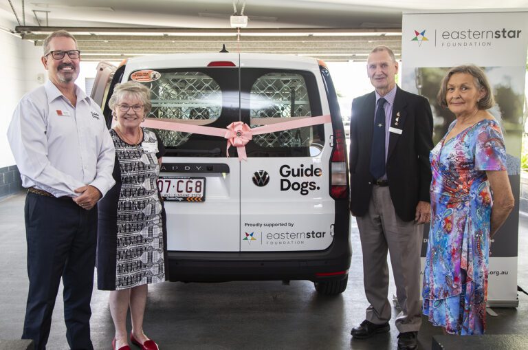 image of Michael Kightly, Guide Dogs CEO and three Eastern Star Foundation Directors in front of Guide Dog's new car. An Eastern Star foundation banner is in the backgroud