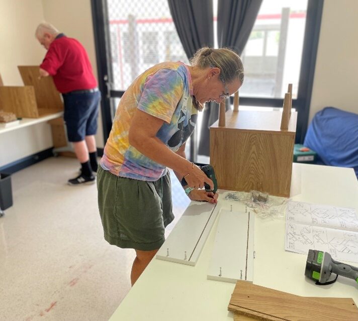 Image of a woman assembling a table