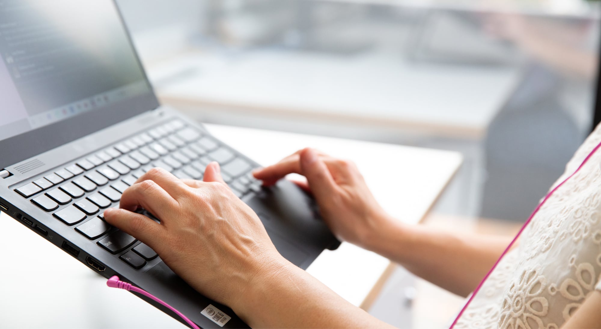 Person's hand using the keyboard of a laptop.
