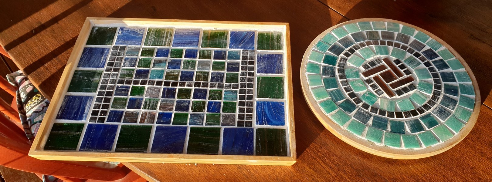 image of two blue mosaic designs, one circle and one square shaped.