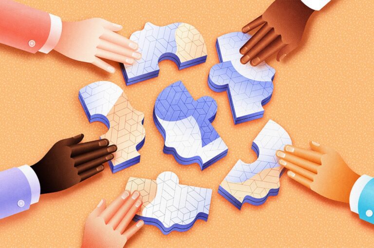 Hands touching a selection of puzzle pieces.