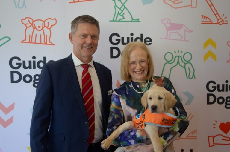 Guide Dogs Queensland CEO Jock Beveridge standing next to Her Excellency the Honourable Dr Jeannette Young, Governor of Queensland.