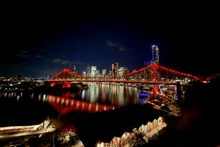 Image shows Brisbane’s Story Bridge glowing orange at night, symbolising support for Guide Dogs and their role in fostering independence and accessibility.