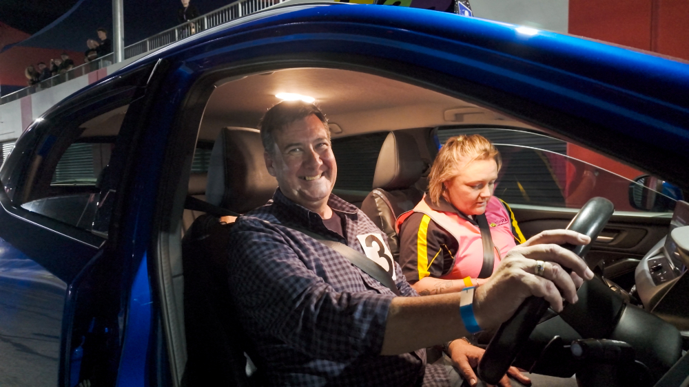 Jason, behind the wheel of a car at the Blind Speed Track Day event.