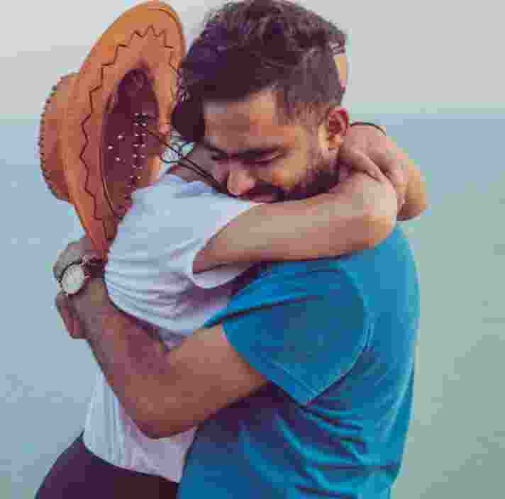 Two people embracing in a hug.