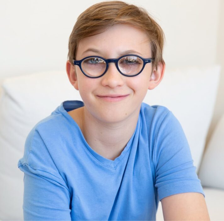 A young child looking at the camera smiling.